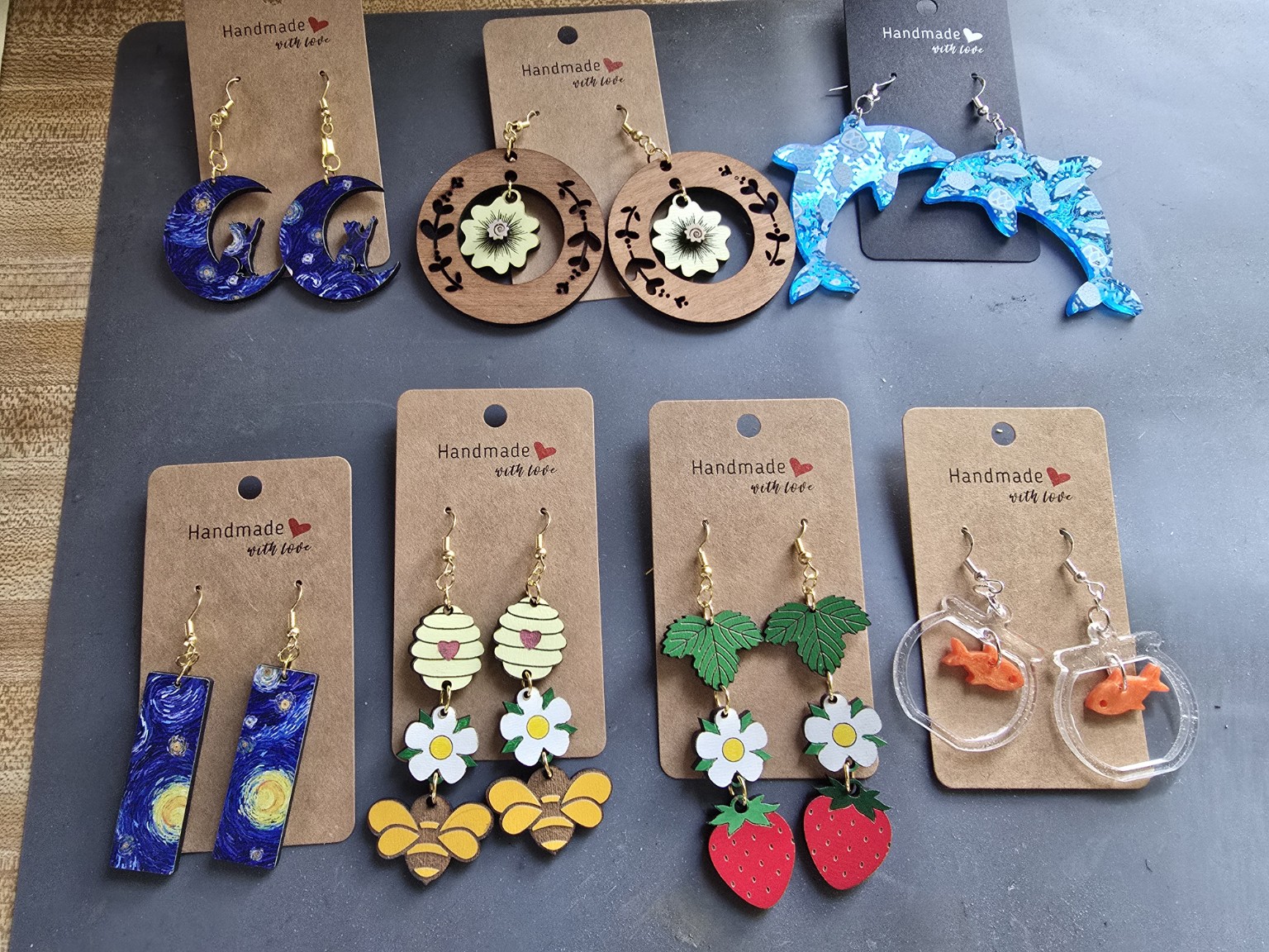 Handmade colorful earrings displayed on jewelry cards