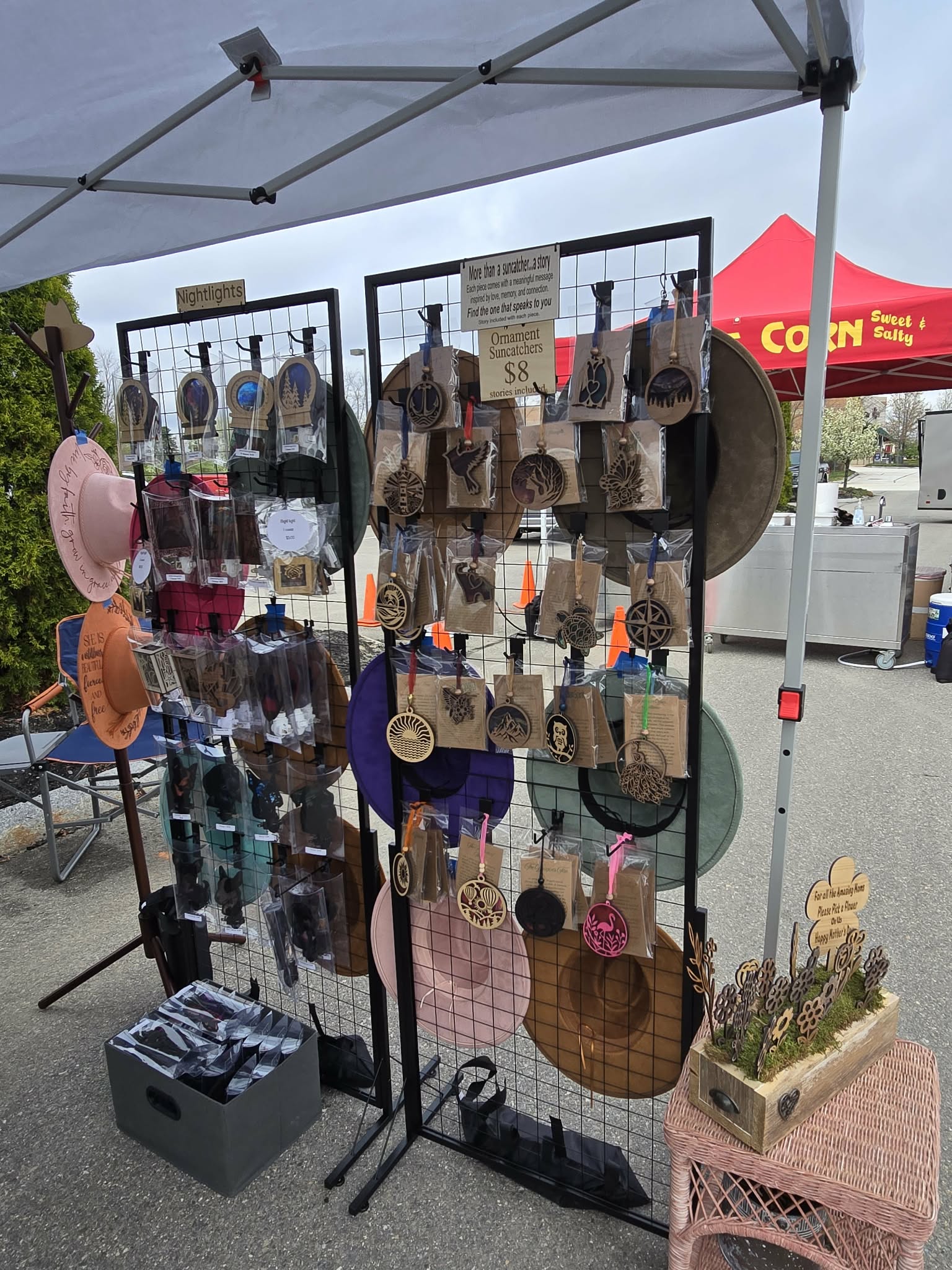 Nightlights and ornament suncatchers displayed on wire grid panels at a market